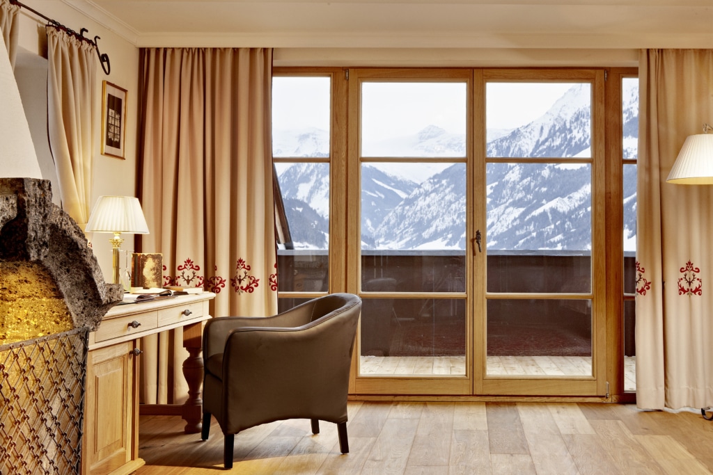 Innenansicht der Clark Gable Suite mit Sitzecke und Zugang zu großer Terrasse mit Ausblick über die Hohen Tauern