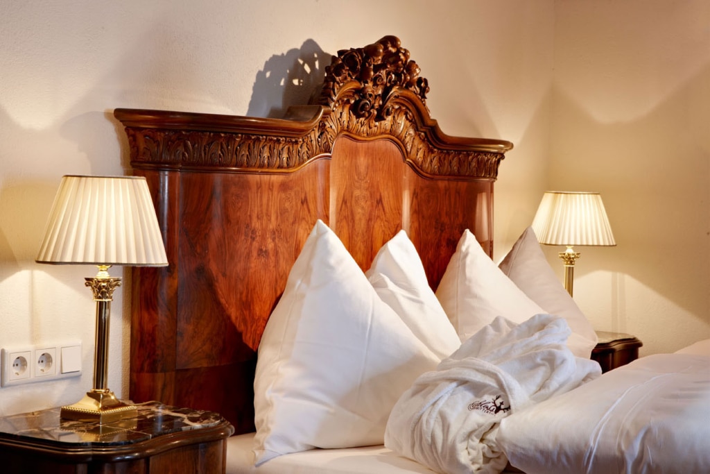 Historisches Doppelbett mit Holzrahmen und Boxspringmatratze